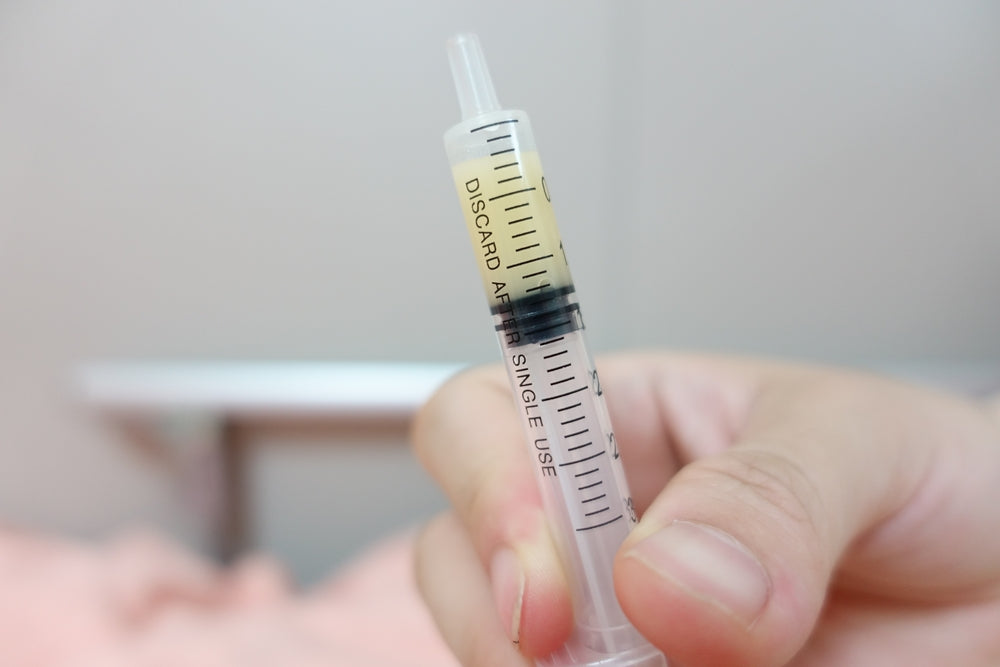 Small syringe of expressed colostrum