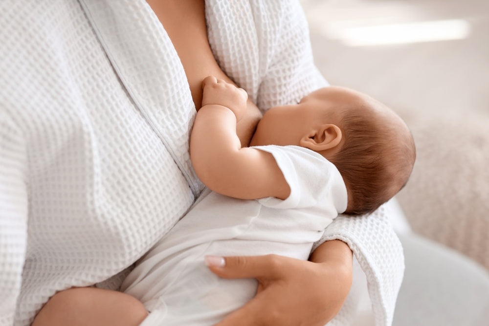 Mum holding her baby close during a feed