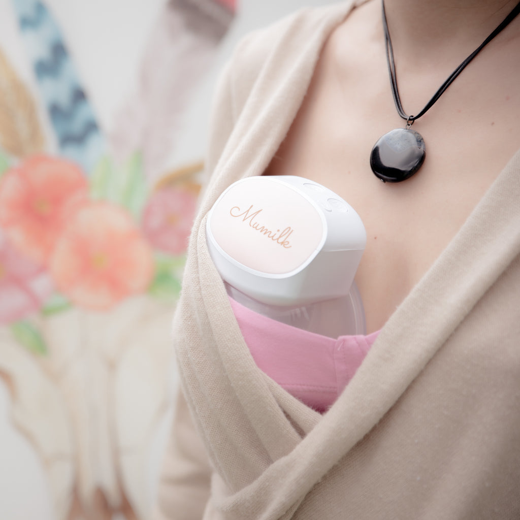 woman wearing a mumilk portable breast pump