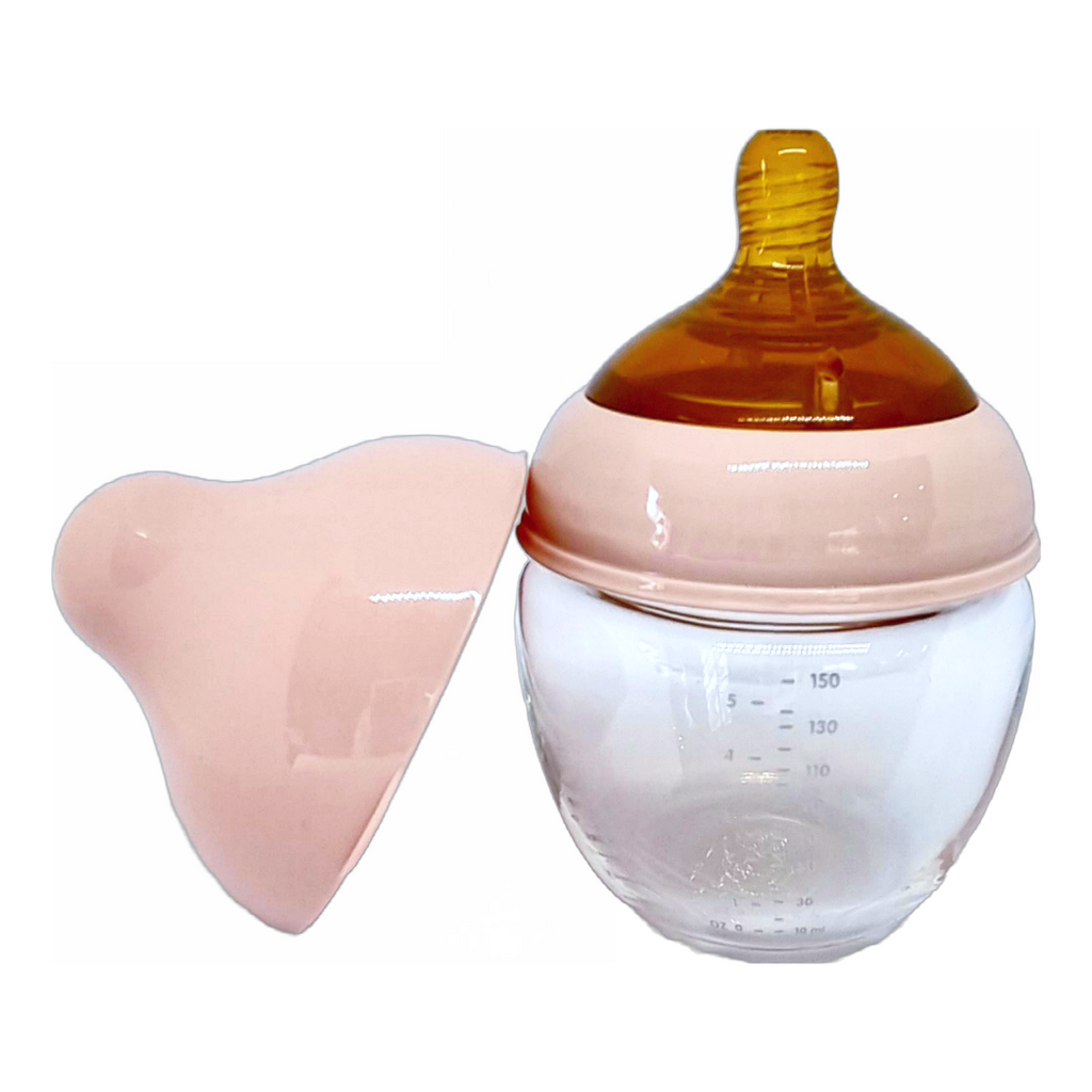 mumilk baby bottle beside a bottle cap